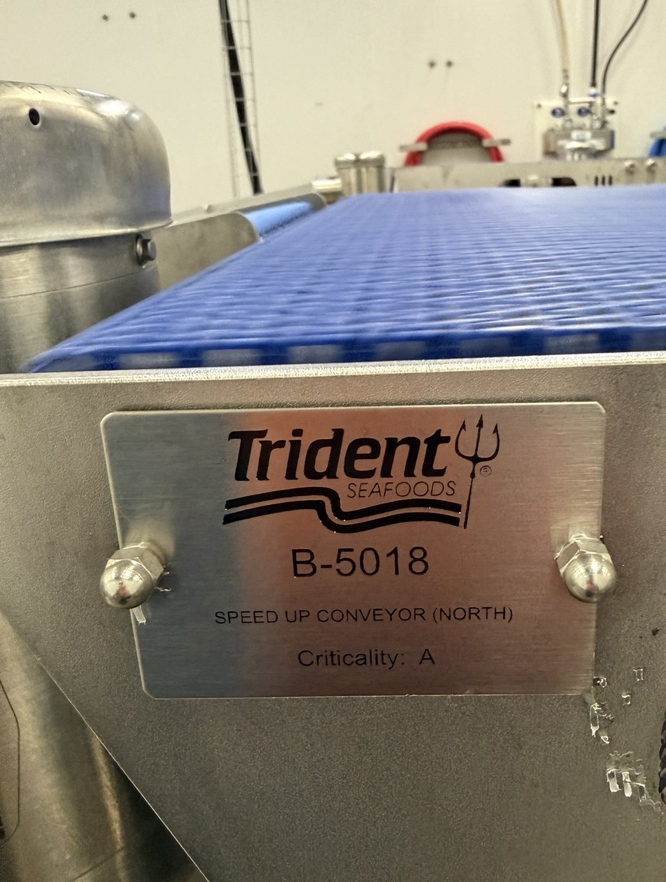 CGATP stainless tag on Trident Seafoods speed-up conveyor B-5018
