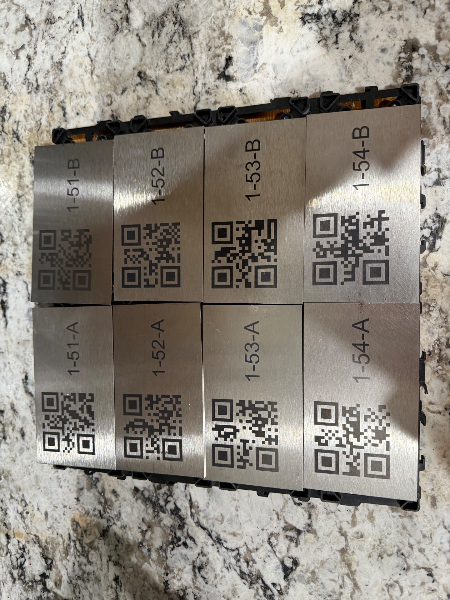 Laser-etched stainless steel cooler tags with QR codes for a Colorado beef jerky company